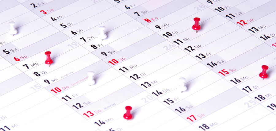Calendar with thumbtacks showing which days had Overtime 