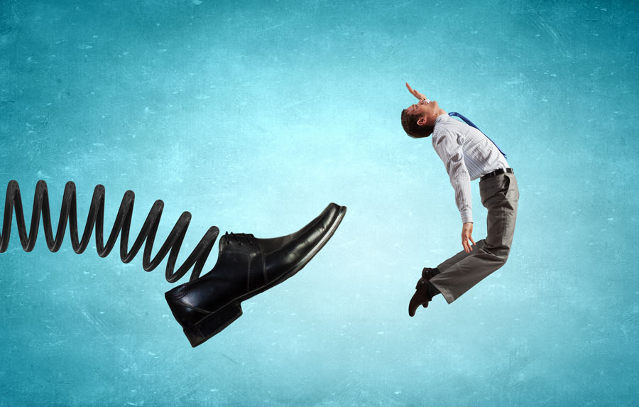 Shoe on a spring kicking employee in the back